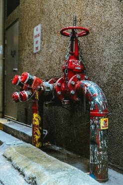 Red metal wheel control valve on heavy duty iron pipe